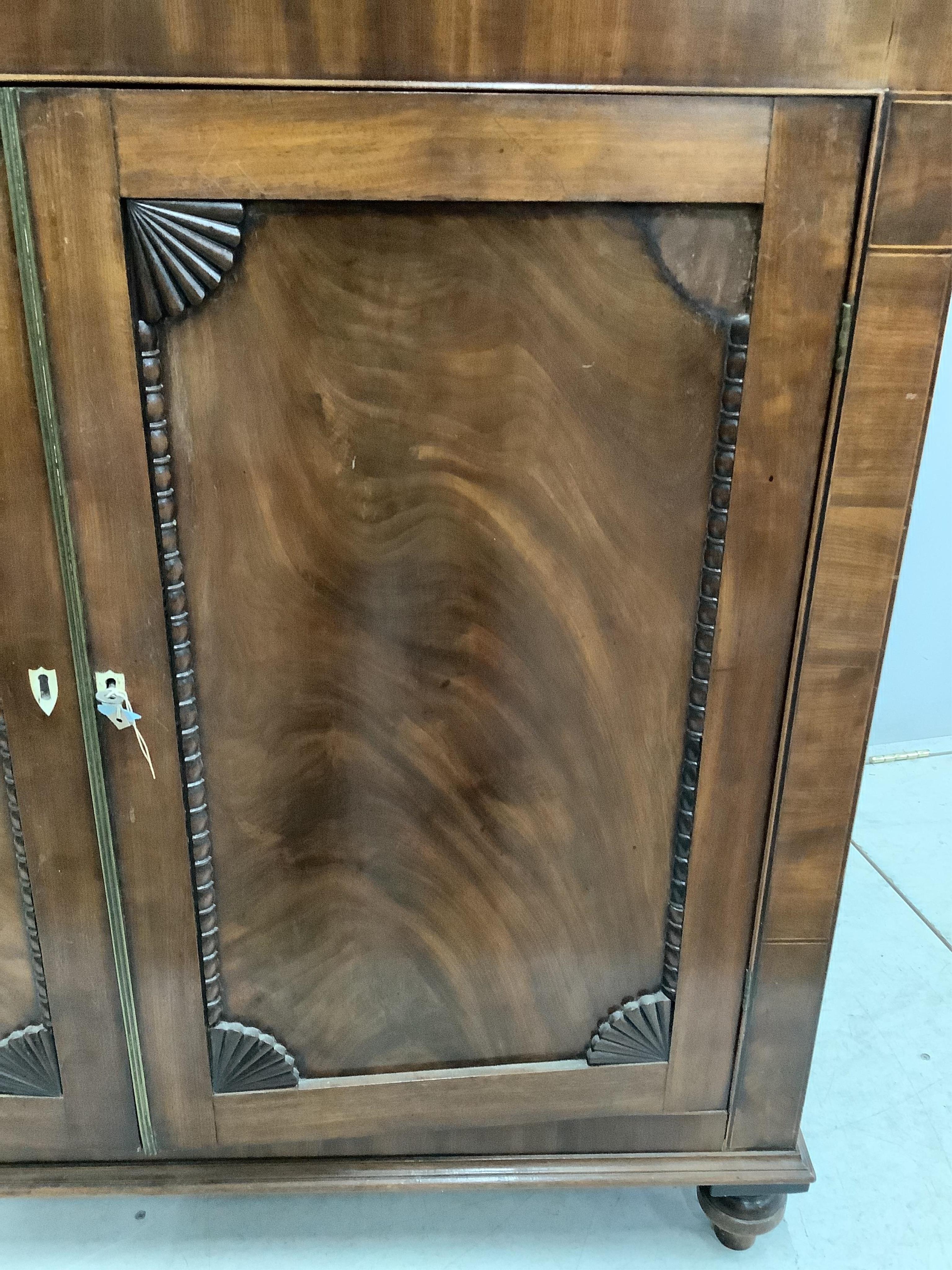 An early Victorian mahogany side cabinet, with bone escutcheons, width 118cm, depth 36cm, height 111cm. Condition - poor to fair